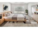 Serene main bedroom featuring a large window and neutral decor at 123 Laurel Springs Dr, Mcdonough, GA 30253