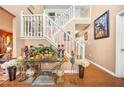 Bright foyer with hardwood floors, stairs to the second floor, and decorative furnishings at 2040 Winding Circle Trl, Fairburn, GA 30213