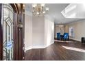 Inviting entryway featuring hardwood floors, a chandelier, and views to the dining room at 409 Angier Ne Ct, Atlanta, GA 30312