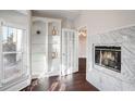 Cozy living room featuring built-in bookshelves, a marble fireplace, and hardwood floors at 409 Angier Ne Ct, Atlanta, GA 30312