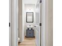 Compact powder room with a pedestal sink and a minimalist design at 5113 Rapahoe Trl, Atlanta, GA 30339