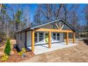 New home featuring a covered front porch with wooden support beams and landscaped front yard at 526 Myrtle St, Villa Rica, GA 30180