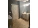 Bathroom with light tile floor, single sink vanity, and storage at 2431 Weatherstone Se Cir, Conyers, GA 30094