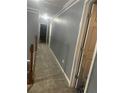 Upstairs hallway with carpet and neutral gray paint at 2431 Weatherstone Se Cir, Conyers, GA 30094