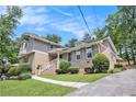 Charming home featuring a brick facade, complemented by lush landscaping, sidewalk and mature trees at 2657 Langland Ne Ct, Atlanta, GA 30345