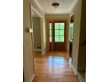 Inviting foyer with gleaming hardwood floors and a charming front door with window panes at 2657 Langland Ne Ct, Atlanta, GA 30345