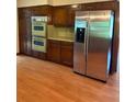 Traditional kitchen with wood cabinets, stainless steel appliances and hardwood flooring at 2657 Langland Ne Ct, Atlanta, GA 30345