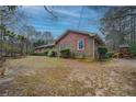 Brick home with charming shutters, lush landscaping, and a backyard play set at 308 Tulipwood Sw Cir, Conyers, GA 30094