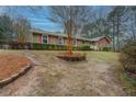 Traditional brick home featuring a landscaped front yard and a cozy, inviting facade at 308 Tulipwood Sw Cir, Conyers, GA 30094