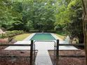 Fenced in backyard featuring a refreshing in-ground swimming pool at 308 Tulipwood Sw Cir, Conyers, GA 30094