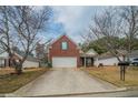 Charming single-Gathering home featuring a brick facade, well-manicured lawn, and attached two-car garage at 4932 Wilkins Station Dr, Decatur, GA 30035