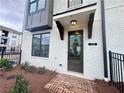 Close up of a townhome entrance with brick walkway and a decorative door frame at 532 Healy Dr # 61, Cumming, GA 30040