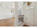 Elegant foyer with hardwood flooring, chandelier, and views into the dining room at 911 Telfair Close, Sandy Springs, GA 30350