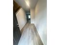 Bright hallway featuring contemporary light-gray wood floors and neutral walls at 100 Deer Xing, Temple, GA 30179