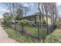 Charming home with a black fence, beautiful foliage, and a well-maintained lawn at 3670 Union Ave, Atlanta, GA 30354