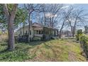 Charming home exterior featuring an overgrown porch with mature trees and a well-maintained lawn at 3670 Union Ave, Atlanta, GA 30354