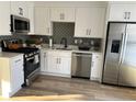 Bright kitchen featuring stainless steel appliances and stylish white cabinets at 1069 Falling Water Se Dr, Smyrna, GA 30080