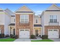 Inviting townhome featuring a stone facade, one-car garage, and covered porch for relaxed curb appeal at 2502 Capella Sw Cir, Atlanta, GA 30331