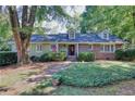 Aerial view of a luxurious home with a pool, patio, and lush greenery at 415 S Woodland Sw Dr, Marietta, GA 30064