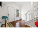 Inviting entryway with hardwood floors, white trim, and a staircase at 6945 Merrywood Dr, Fairburn, GA 30213