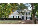 Charming home featuring a two-story entrance, manicured lawn, and inviting walkway at 6815 Fairgreen Dr, Suwanee, GA 30024