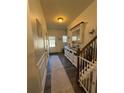 Inviting hallway features wood floors, decorative console table with mirror, and a view of the front door at 307 Morning Frost, Canton, GA 30114