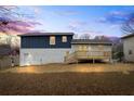 Exterior view of the home with a deck and backyard at 3565 Collier Drive Nw Rd, Atlanta, GA 30331