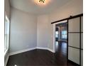 Bright bedroom featuring modern sliding doors, a window, and hardwood floors at 958 Joseph E Boone Nw Blvd, Atlanta, GA 30314