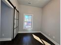 Bright bedroom featuring modern sliding doors, a window, and hardwood floors at 958 Joseph E Boone Nw Blvd, Atlanta, GA 30314