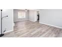 Open floor plan featuring a ceiling fan, wood grain floors, and soft gray walls at 1650 Seayes Sw Rd, Mableton, GA 30126