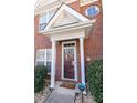 Close-up of the home's front door with white pillars and a security system at 2021 Austin Park Cir, Decatur, GA 30032