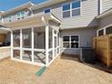 View of covered and screened porch with white trim, overhead lighting, and gray siding at 1312 Fern Ridge Ct # 78, Norcross, GA 30093