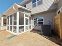 View of covered and screened porch with white trim, overhead lighting, and gray siding at 1312 Fern Ridge Ct # 78, Norcross, GA 30093