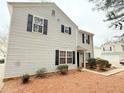 Two story home showcasing vinyl siding, black shutters, and minimal landscaping at 235 Windcroft Nw Ln, Acworth, GA 30101