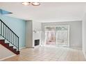A bright living room with tile flooring, a brick fireplace, and access to the backyard at 2551 Bradford Ne Sq, Atlanta, GA 30345
