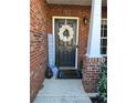 Cozy front porch entrance, with brick columns and festive wreath and decorations at 3148 Glenloch Pl, Lawrenceville, GA 30044