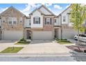 Charming brick and siding townhomes with attached garages and well-maintained landscaping create inviting curb appeal at 1409 Ben Park Way, Grayson, GA 30017