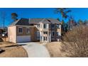 Elegant two-story stucco home with a well-manicured lawn and a paved driveway leading to an attached garage at 4197 Trotters Way Dr, Snellville, GA 30039