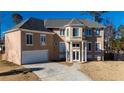 Elegant two-story stucco home with a well-manicured lawn and a paved driveway leading to an attached garage at 4197 Trotters Way Dr, Snellville, GA 30039