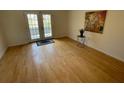 Bright living room with wood floors and french doors leading to the outdoors at 5400 Roswell Rd # K1, Atlanta, GA 30342