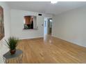 Spacious living room with gleaming hardwood floors and a view of the kitchen at 5400 Roswell Rd # K1, Atlanta, GA 30342