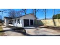 Side view of home showcasing a spacious two-car garage and newly installed wooden fence at 1390 White Oak St Se, Conyers, GA 30013