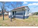 Exterior view of a cozy home with a inviting front porch and a small yard, creating a welcoming curb appeal at 1820 Spring St, Conyers, GA 30012