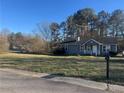 Exterior view of a well-kept home with a big front lawn at 57 Haven Ridge Dr, Carrollton, GA 30116