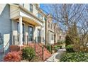Beautiful townhome exterior with brick steps and lush landscaping along the sidewalk at 327 Alderwood Ln, Atlanta, GA 30328