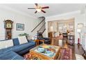 Cozy living room with hardwood floors, open staircase, and plenty of natural light at 327 Alderwood Ln, Atlanta, GA 30328