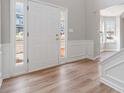 Welcoming entryway with hardwood floors, wainscoting and natural light streaming through sidelight windows at 4284 Hathaway Nw Ct, Kennesaw, GA 30144