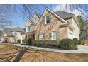Attractive two-story home with brick facade, green shutters, and professionally landscaped yard at 448 Cape Ivey Dr, Dacula, GA 30019