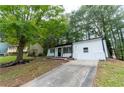 Well-maintained single-Gathering home with a long driveway, surrounded by mature trees providing ample shade and privacy at 1995 Northerly Way, Stone Mountain, GA 30088