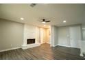 Inviting living room features a stone fireplace, neutral paint, recessed lighting, and stylish wood-look laminate flooring at 1995 Northerly Way, Stone Mountain, GA 30088